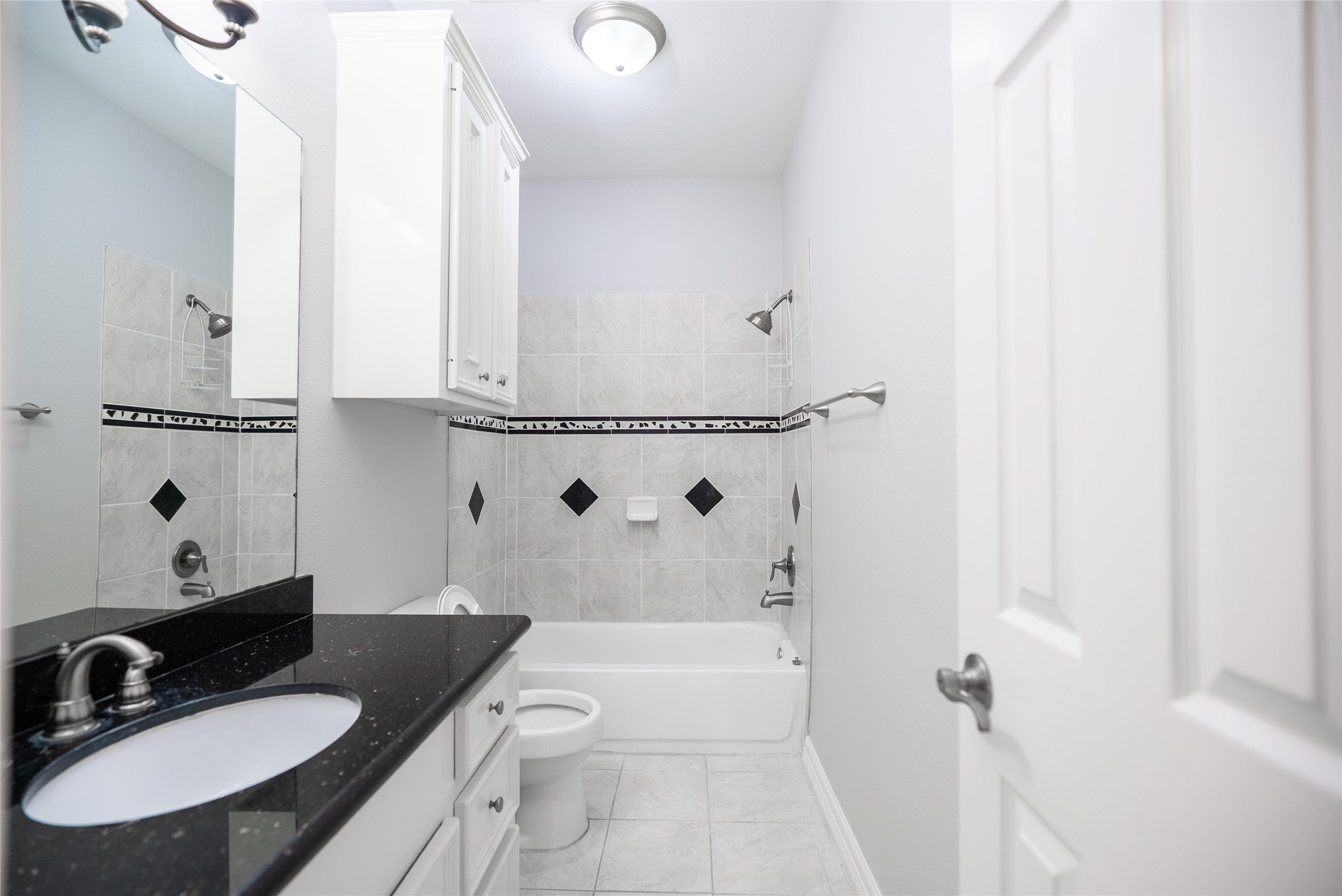 13165 Snow Lane, Unit 1 Willis, TX 77318 - Photo 30 of 34 a bathroom with a sink and a mirror