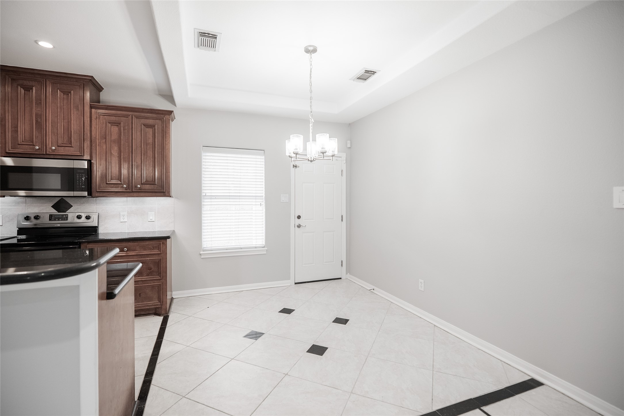13165 Snow Lane, Unit 1 Willis, TX 77318 - Photo 5 of 34 a kitchen with granite countertop a sink cabinets and stainless steel appliances