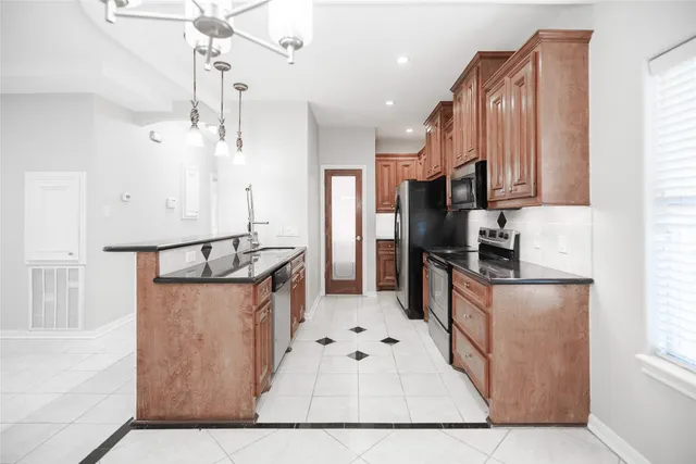 a kitchen with granite countertop cabinets stainless steel appliances and wooden cabinets
