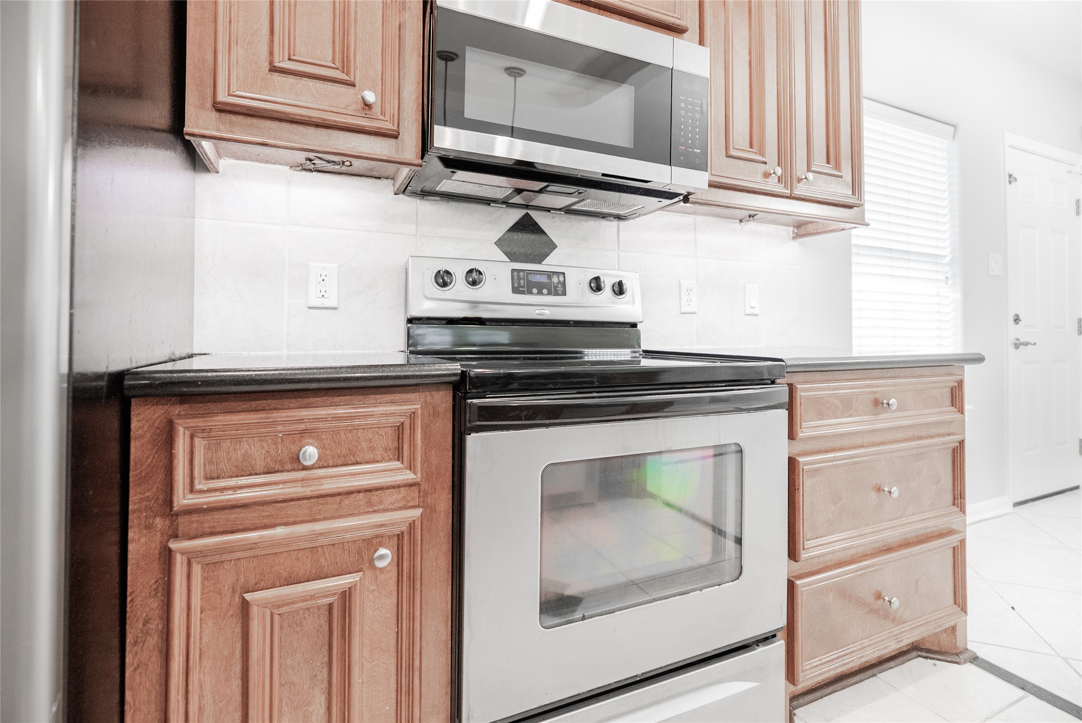 13165 Snow Lane, Unit 1 Willis, TX 77318 - Photo 9 of 34 a kitchen with granite countertop cabinets stainless steel appliances and wooden cabinets