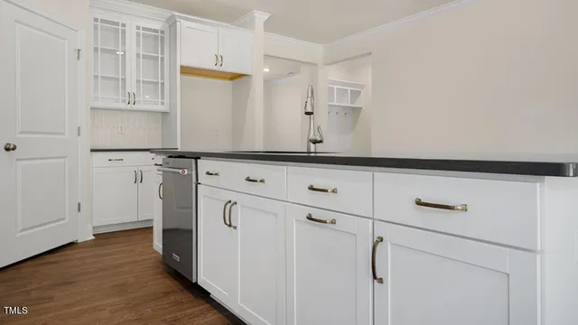 a kitchen with granite countertop white cabinets and white appliances
