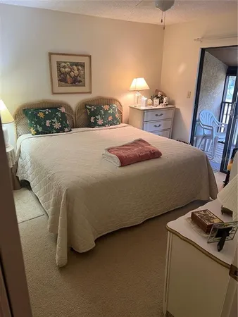 a bedroom with a bed and a lamp