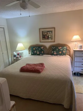 a bedroom with a bed and a lamp
