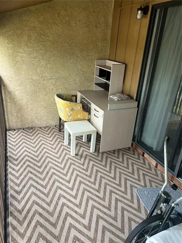 a view of a patio with table and chairs