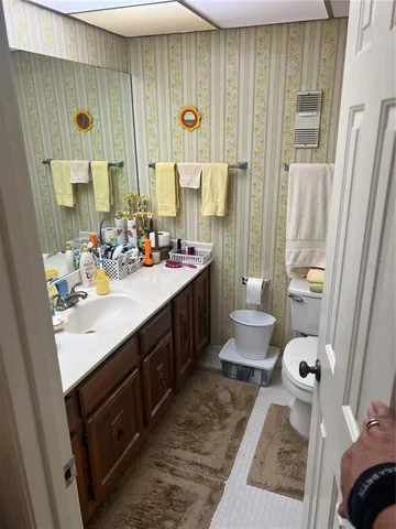 a bathroom with a double vanity sink toilet and shower