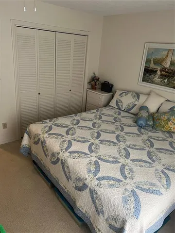 a bedroom with a bed and painting on the wall