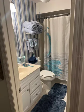 a bathroom with a toilet a sink and a shower