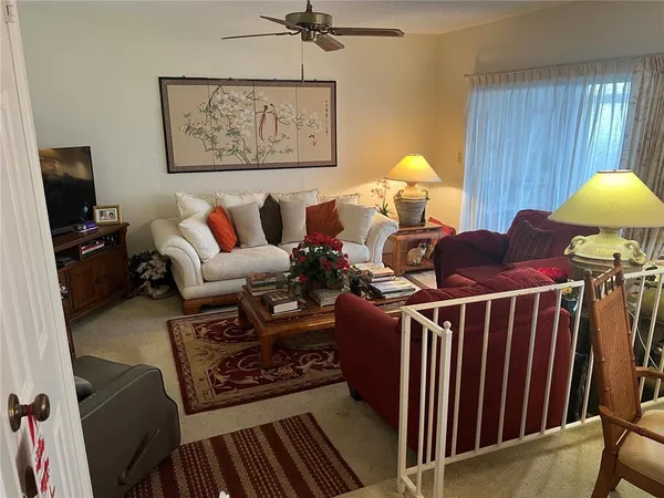 a living room with furniture a window and a flat screen tv