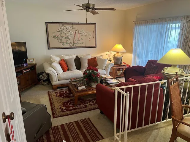 a living room with furniture a window and a flat screen tv