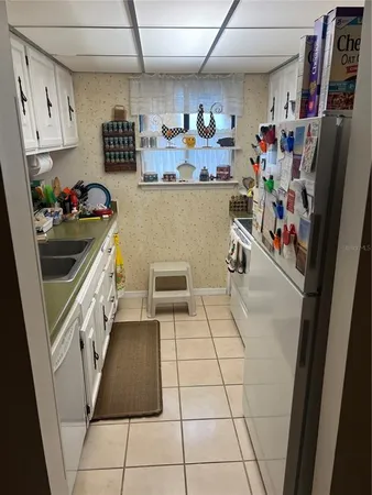 a kitchen with stainless steel appliances granite countertop a refrigerator and a stove
