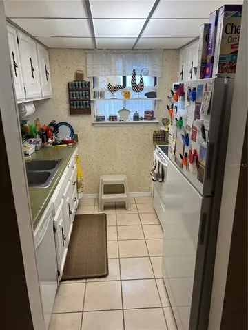 a kitchen with stainless steel appliances granite countertop a refrigerator and a stove