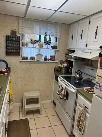 a kitchen with stainless steel appliances granite countertop a stove and a cabinets