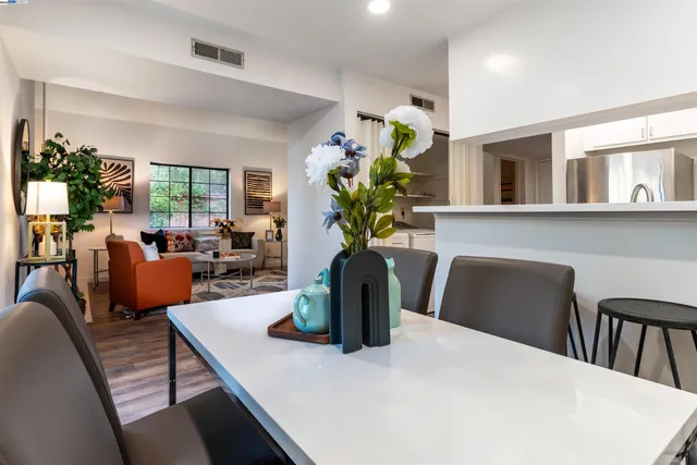 a view of a dining room with furniture and a potted plant