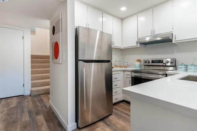 a kitchen with stainless steel appliances a refrigerator and a stove