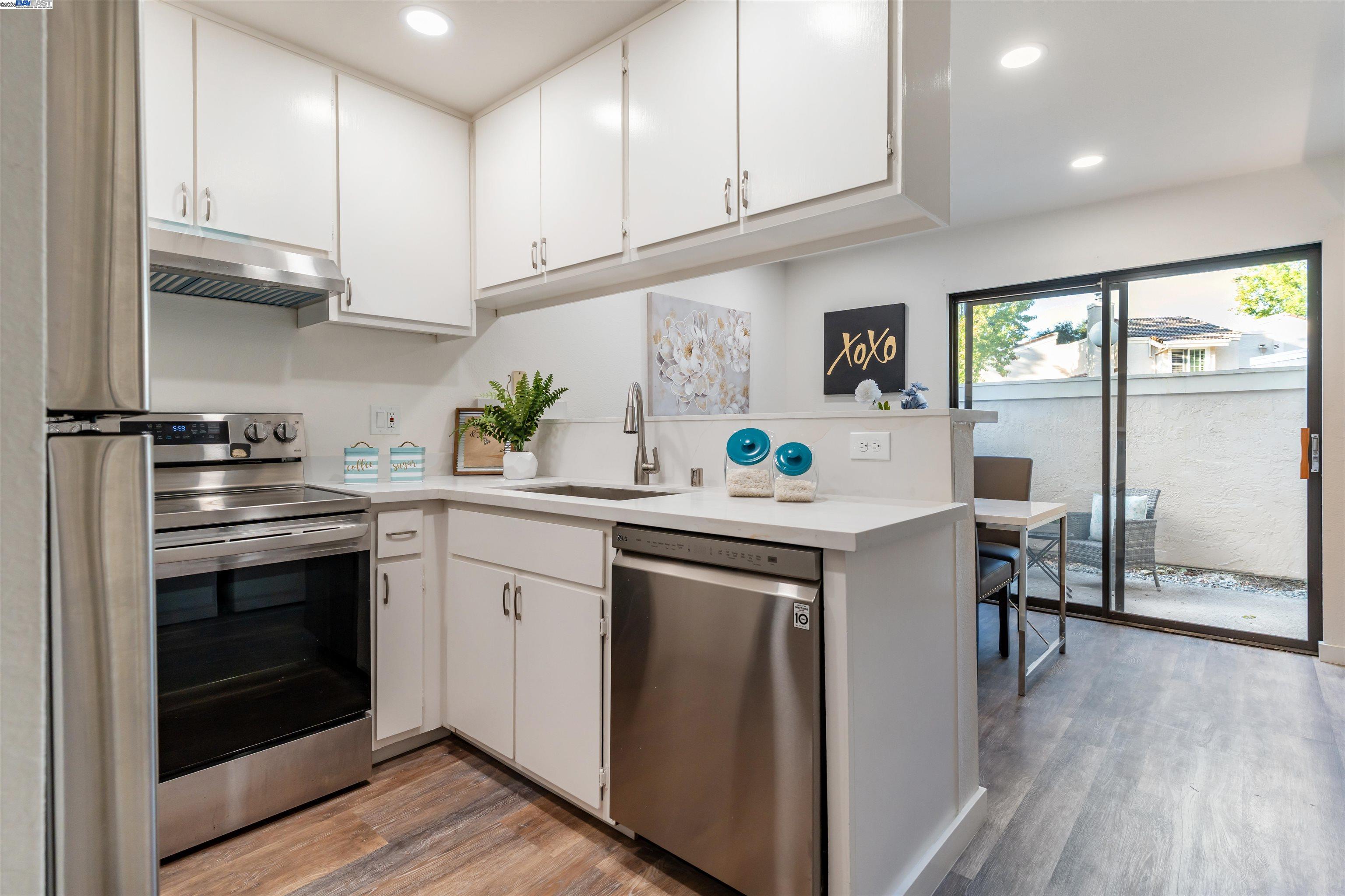 601 Palomino Drive, Unit C Pleasanton, CA 94566 - Photo 17 of 41 a kitchen with stainless steel appliances granite countertop a stove a sink and a refrigerator