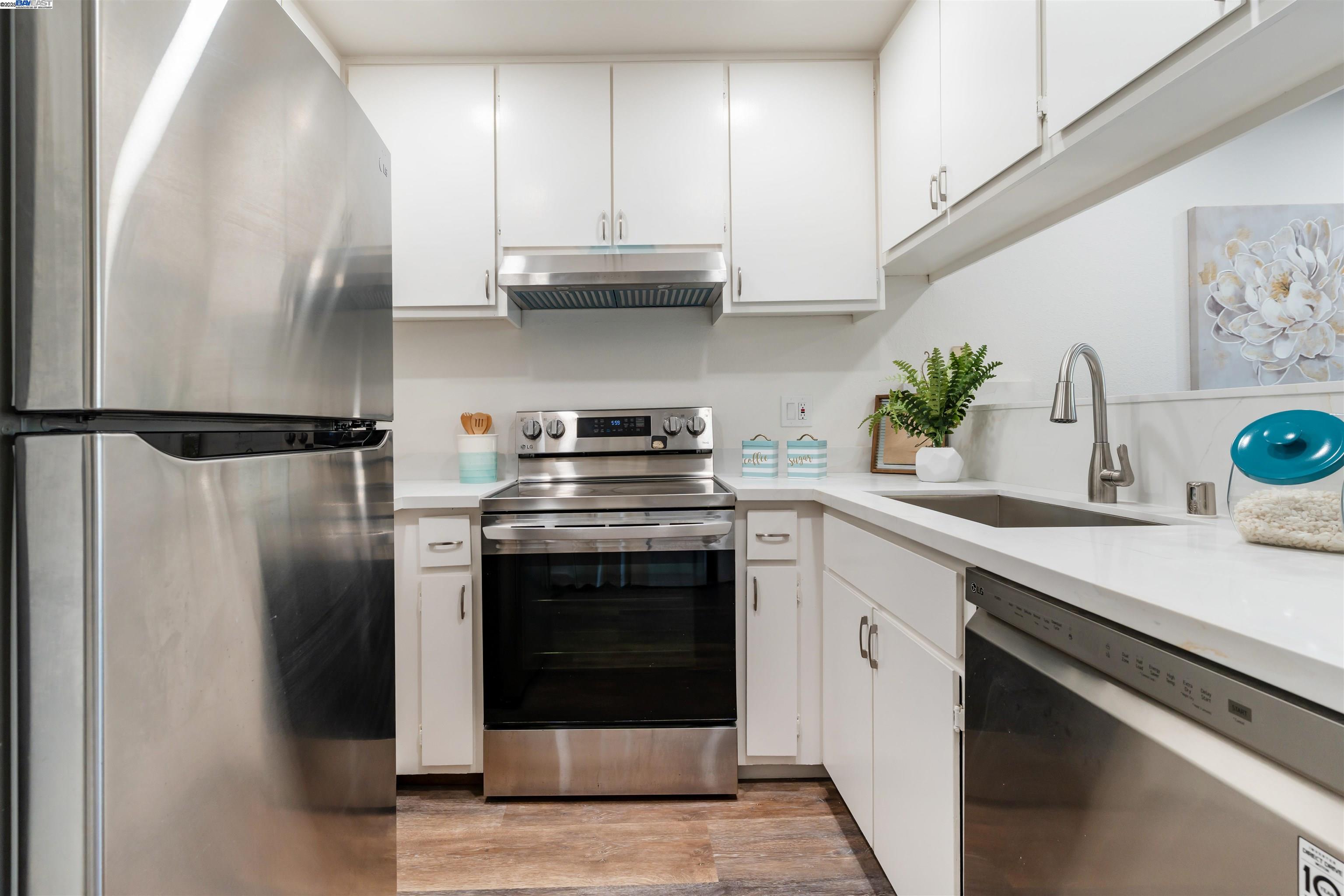 601 Palomino Drive, Unit C Pleasanton, CA 94566 - Photo 18 of 41 a kitchen with stainless steel appliances a stove a sink and a refrigerator