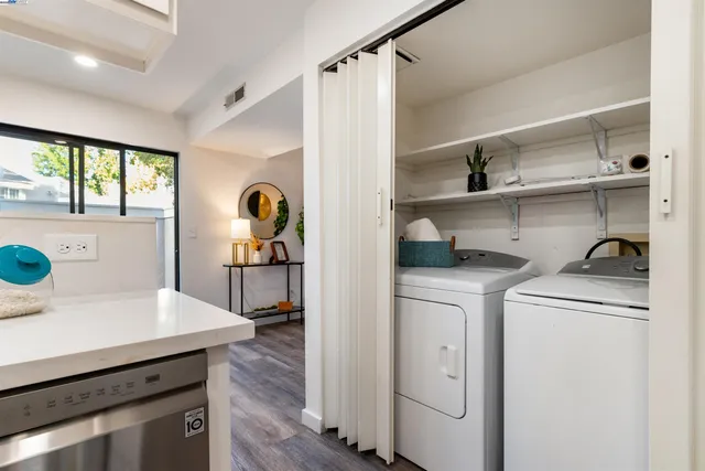 a view of cabinets a washer and dryer