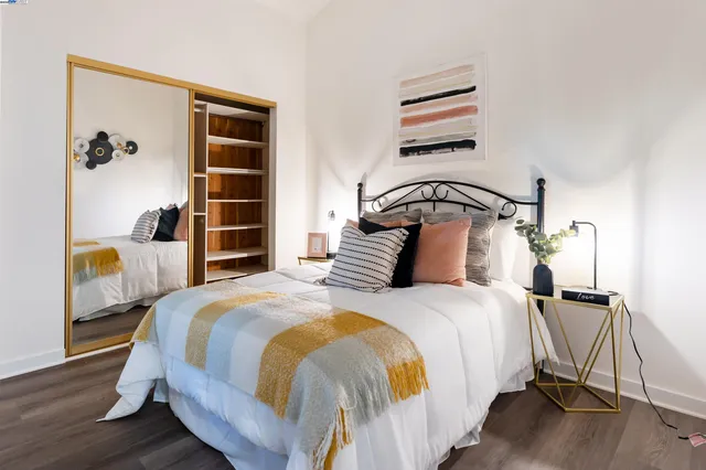 a bedroom with a bed and wooden floor