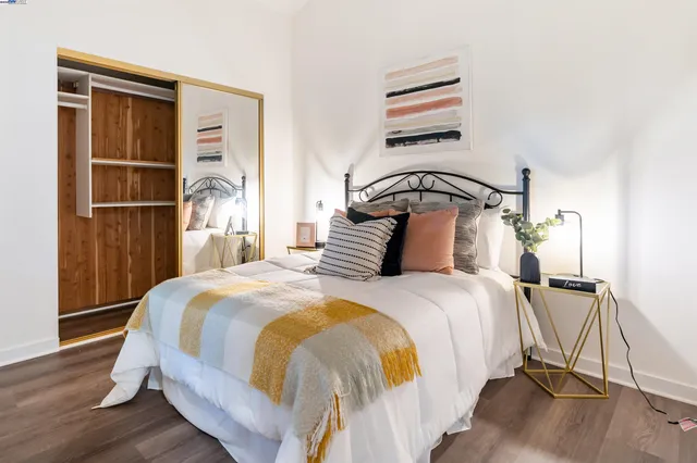 a bedroom with a bed a chandelier and a window