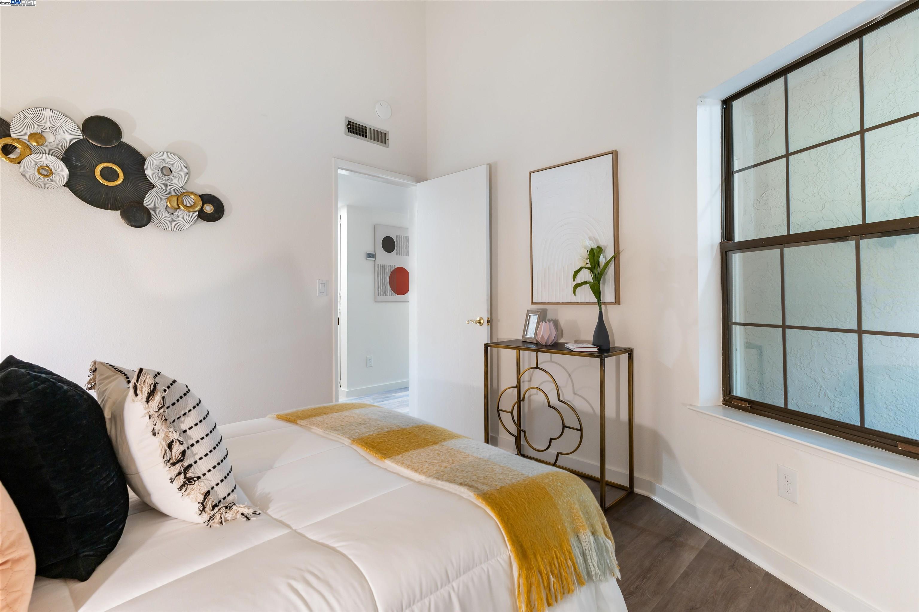 601 Palomino Drive, Unit C Pleasanton, CA 94566 - Photo 27 of 41 a bedroom with a bed a chandelier and a window