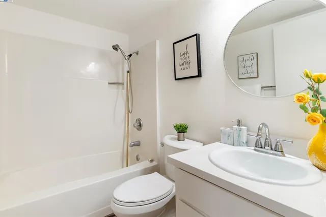 a living room with furniture and a book shelf
