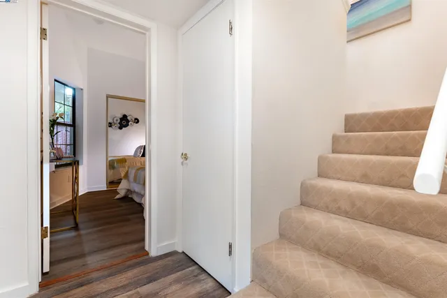 a view of a hallway with wooden floor and entryway