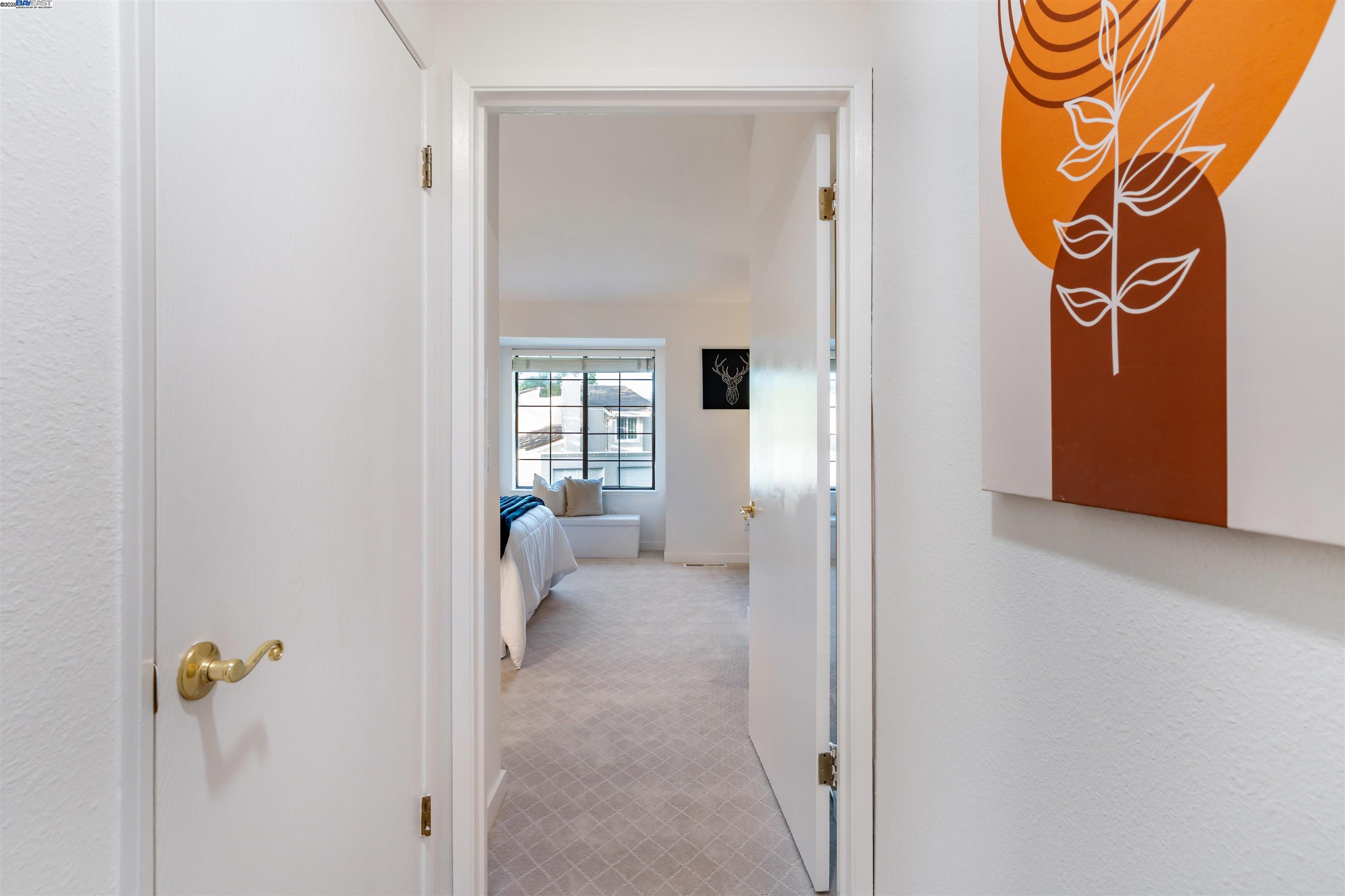 601 Palomino Drive, Unit C Pleasanton, CA 94566 - Photo 32 of 41 a view of a hallway with wooden floor and a livingroom