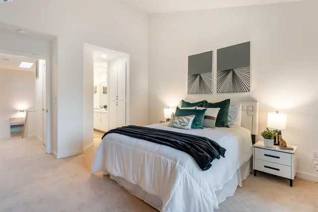 a bedroom with a bed and mirror