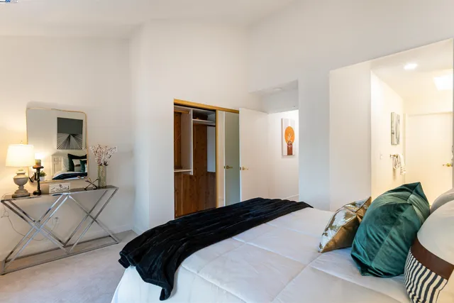 a bedroom with a bed and a painting on the wall