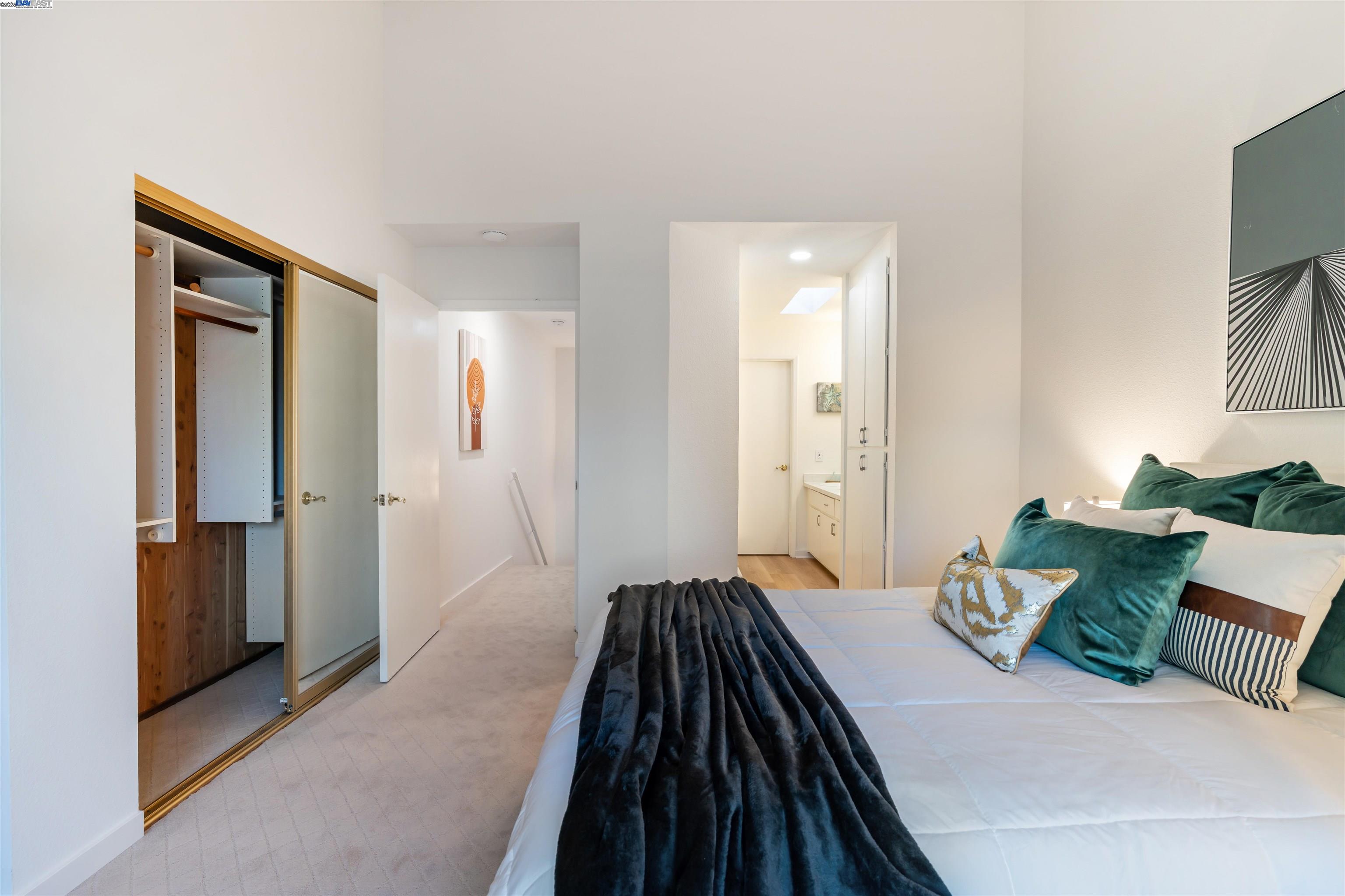 601 Palomino Drive, Unit C Pleasanton, CA 94566 - Photo 36 of 41 a bedroom with a bed and a painting on the wall