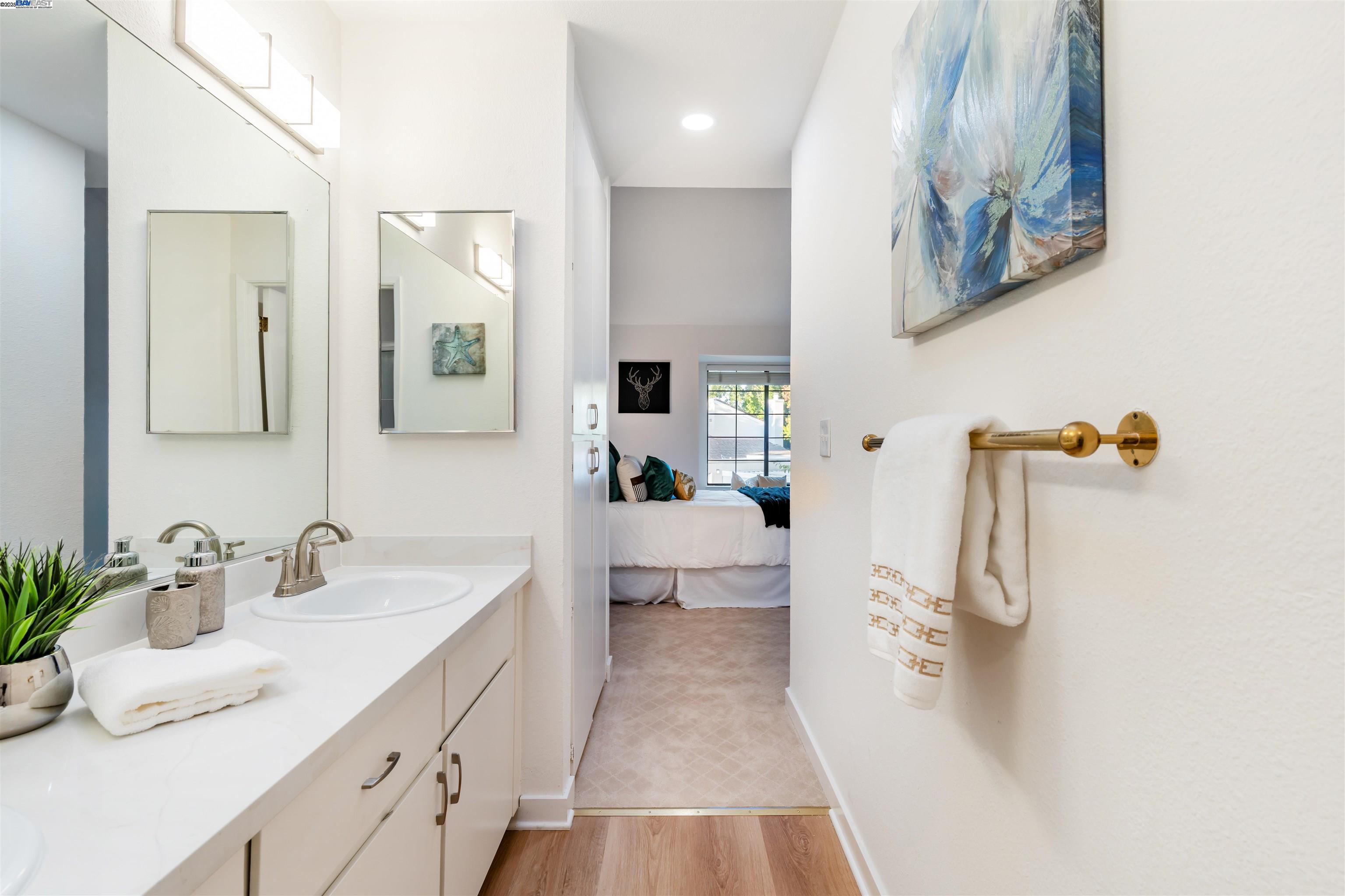 601 Palomino Drive, Unit C Pleasanton, CA 94566 - Photo 39 of 41 a en suite bathroom with a double vanity sink and a mirror