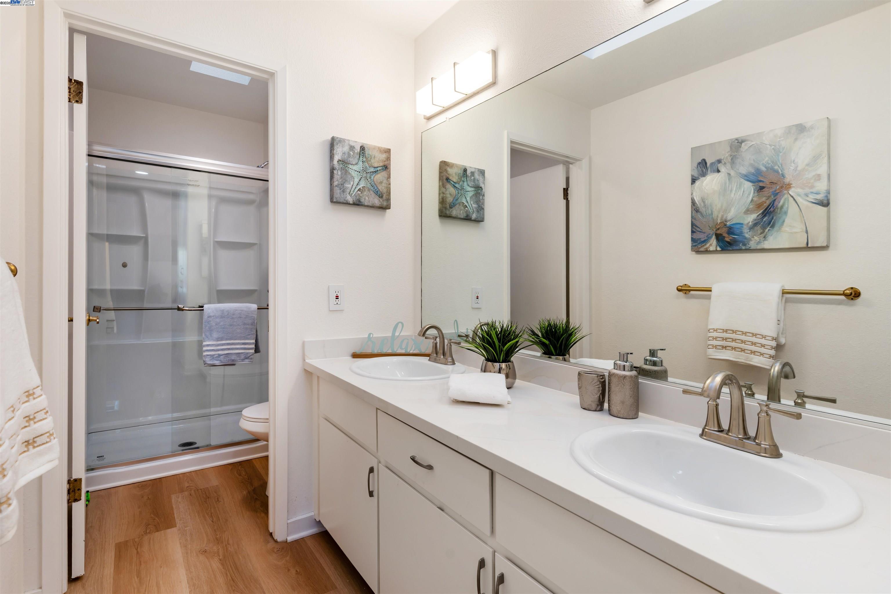 601 Palomino Drive, Unit C Pleasanton, CA 94566 - Photo 40 of 41 a bathroom with a granite countertop sink mirror toilet and shower
