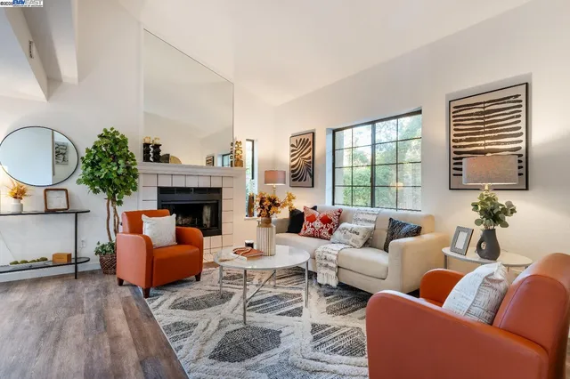 a living room with furniture fireplace and a large window
