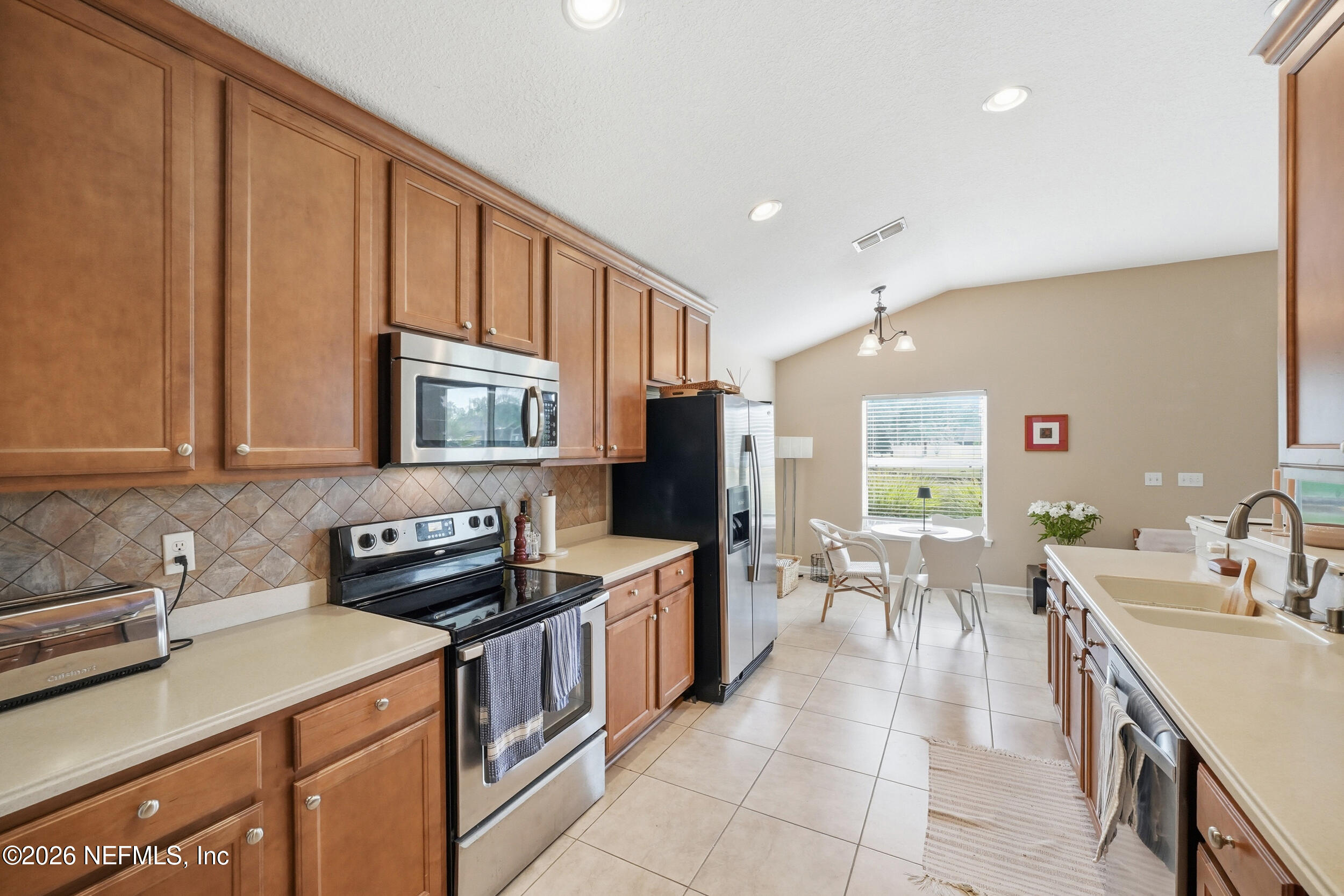 374 Porta Rosa Circle St. Augustine, FL 32092 - Photo 15 of 47 a kitchen with stainless steel appliances granite countertop a sink stove and cabinets