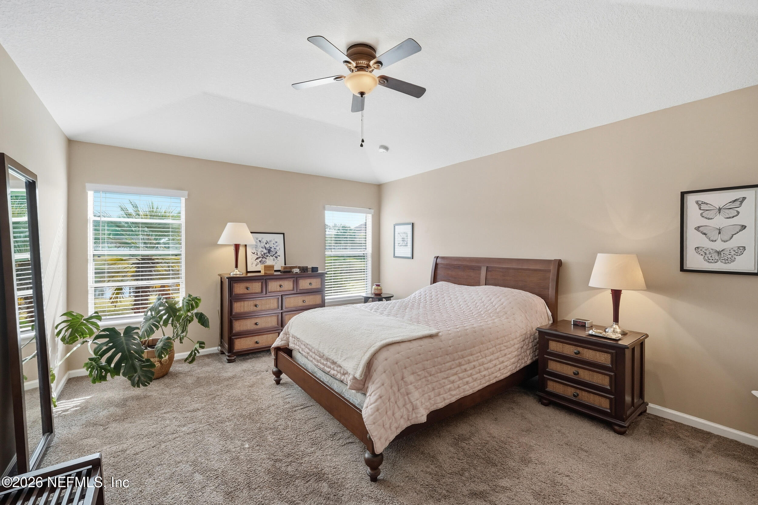 374 Porta Rosa Circle St. Augustine, FL 32092 - Photo 18 of 47 a spacious bedroom with a bed a chandelier and a potted plant