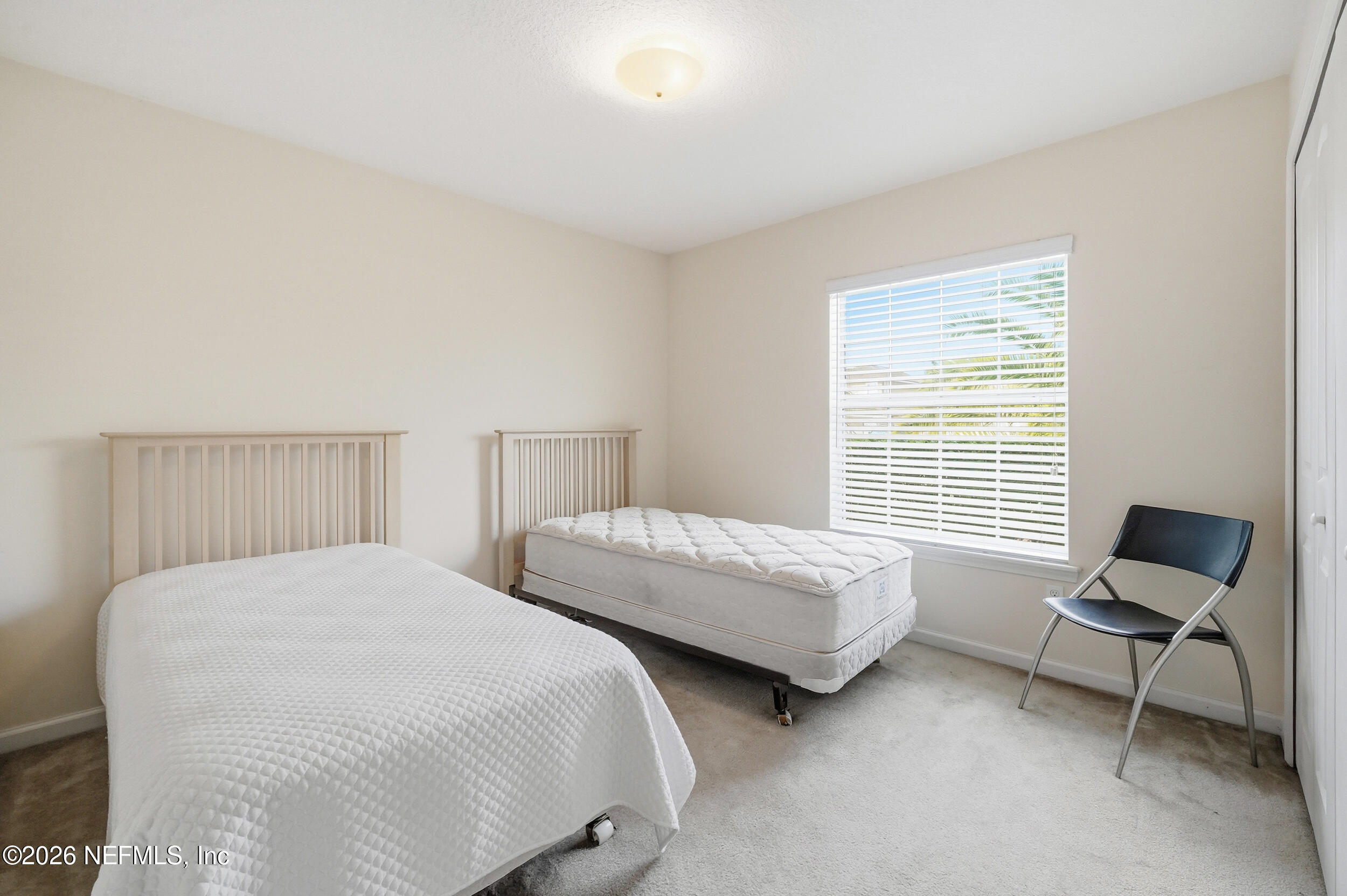 374 Porta Rosa Circle St. Augustine, FL 32092 - Photo 24 of 47 a bedroom with two beds and a chair