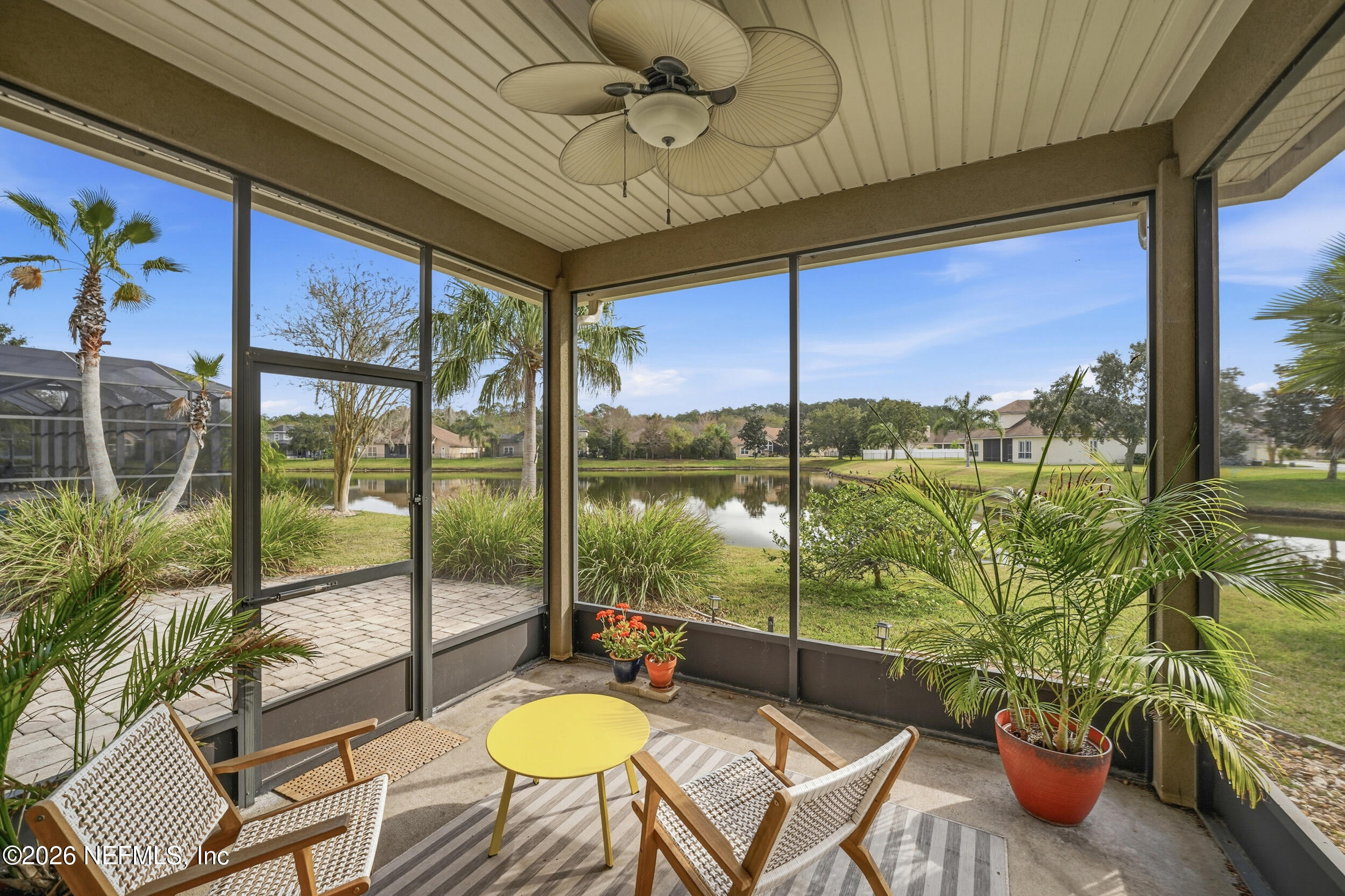 374 Porta Rosa Circle St. Augustine, FL 32092 - Photo 30 of 47 a living room with patio furniture and a floor to ceiling window