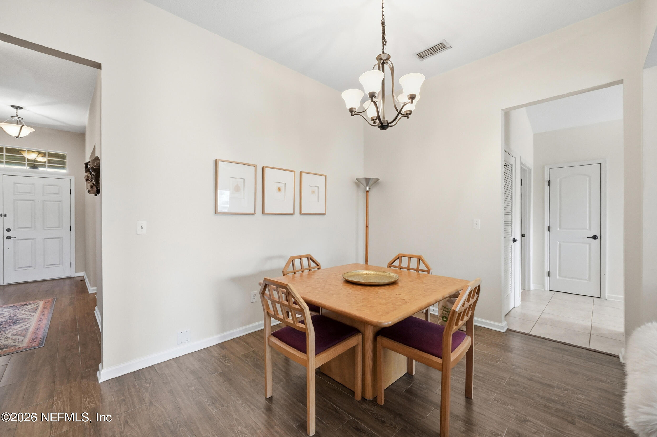 374 Porta Rosa Circle St. Augustine, FL 32092 - Photo 9 of 47 a view of a dining room with wooden floor a chandelier a wooden table and chairs