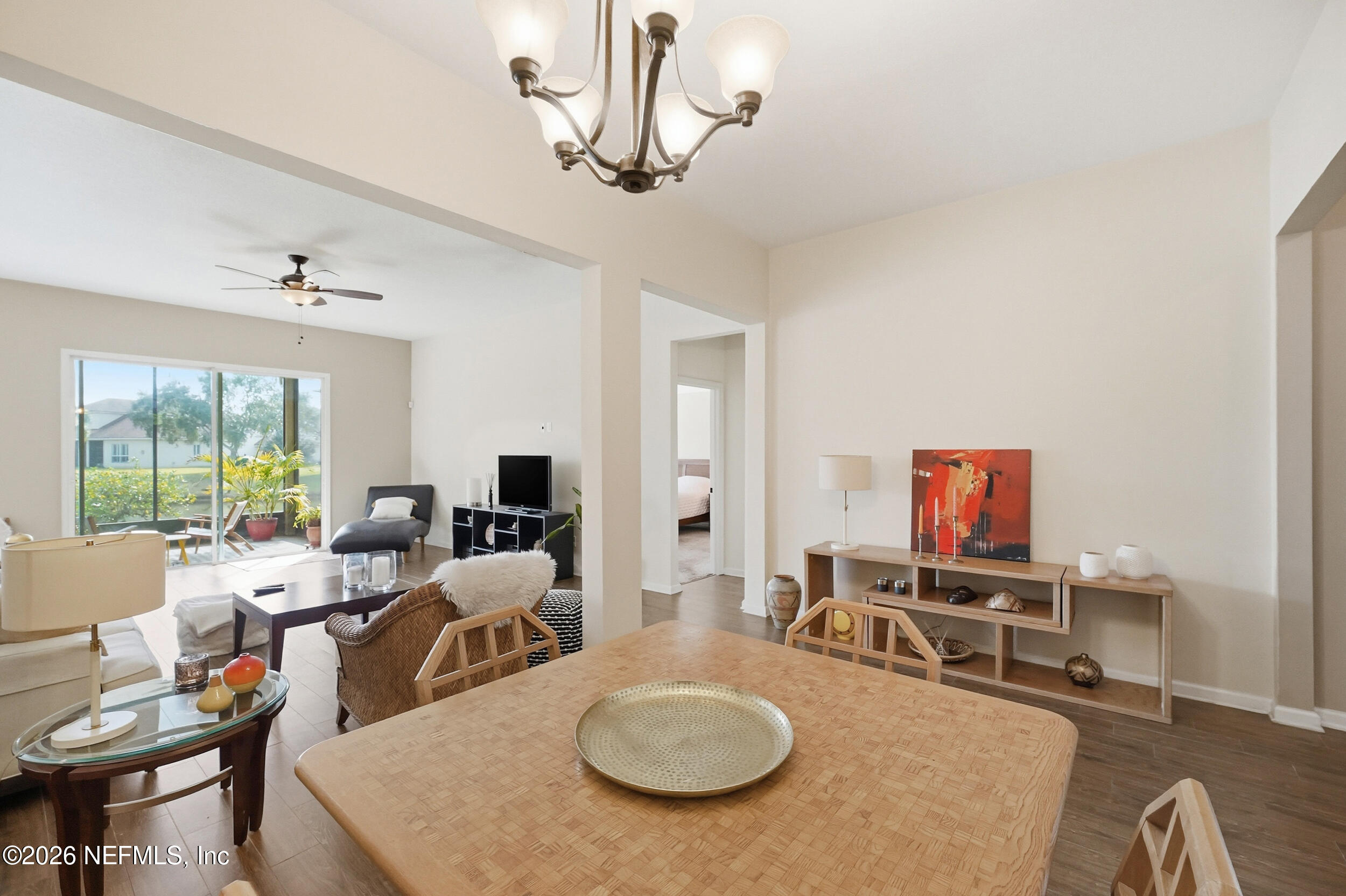 374 Porta Rosa Circle St. Augustine, FL 32092 - Photo 10 of 47 a living room with furniture a rug and a chandelier