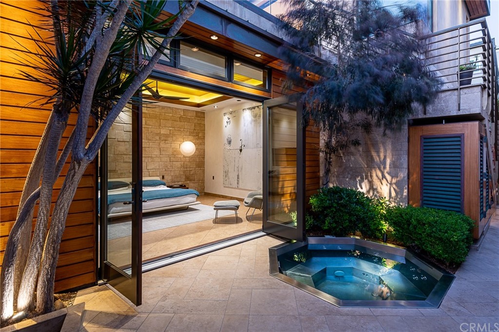 2804 The Strand Manhattan Beach, CA 90266 - Photo 17 of 51 a view of a house with a patio and garden