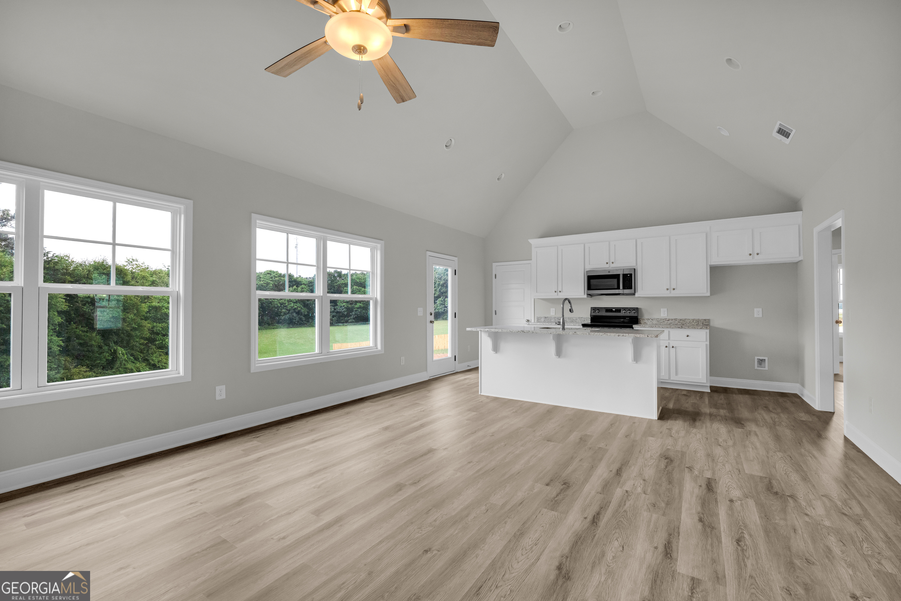 110 Sewell Road Lavonia, GA 30553 - Photo 28 of 73 a view of kitchen with stainless steel appliances kitchen island wooden floor and window