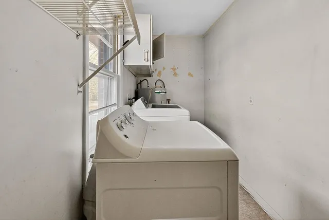 a kitchen with granite countertop a stove a sink and a refrigerator