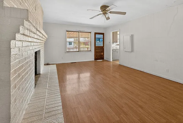 a kitchen with refrigerator cabinets and large window