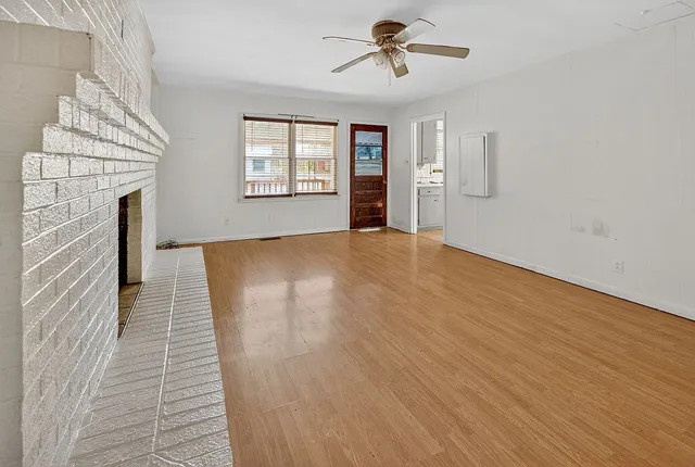 wooden floor in an empty room with a window