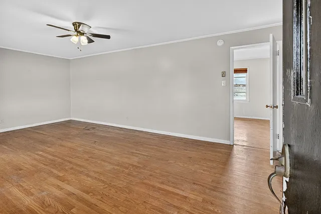 wooden floor in an empty room with a window