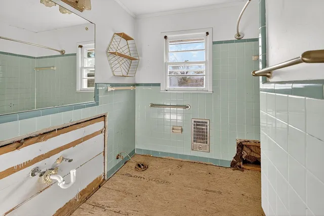 a view of a kitchen with wooden floor and a window