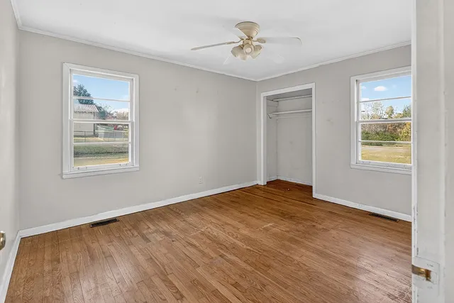 an empty room with a empty space and chandelier fan