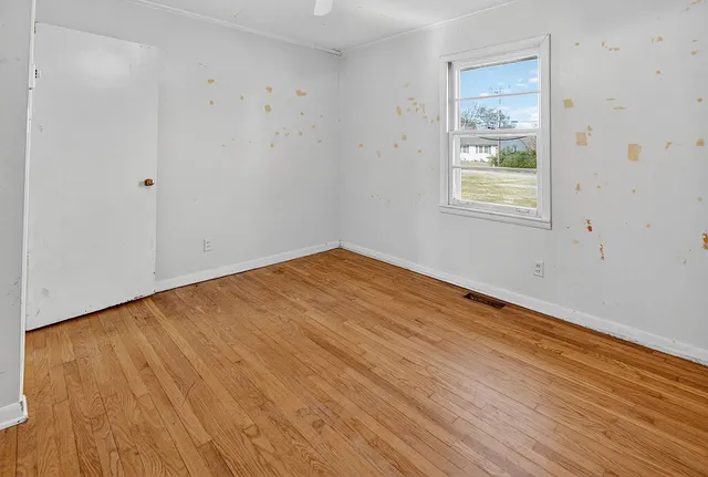 a kitchen with a stove and a wooden floor