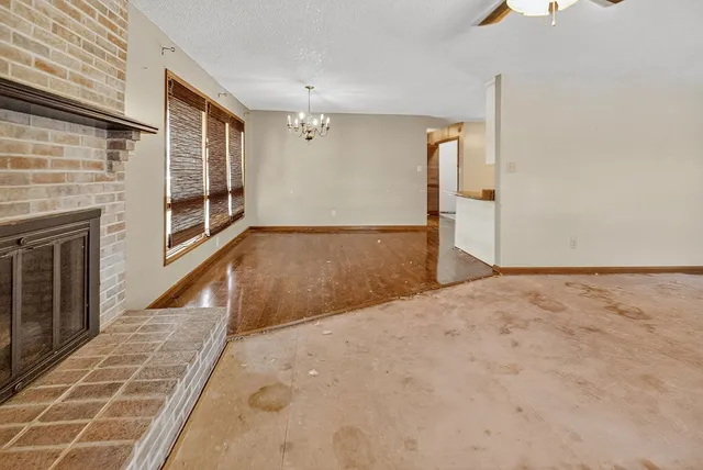 a view of a house with a yard and potted plants
