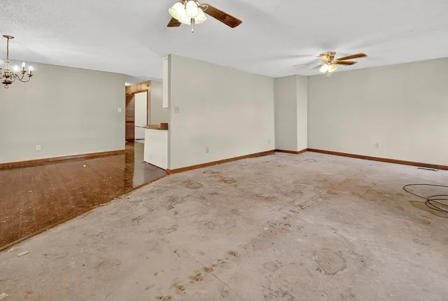 a front view of a house with a big yard and potted plants